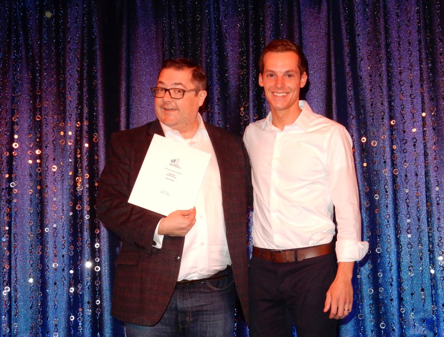 John Holl receives a North American Guild of Beer Writers award from Brian Roth