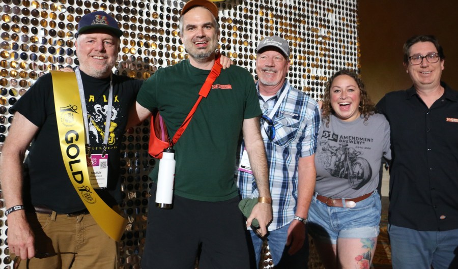 Members of the 21st Amendment Brewing crew smile for photos after winning a World Beer Cup Gold.