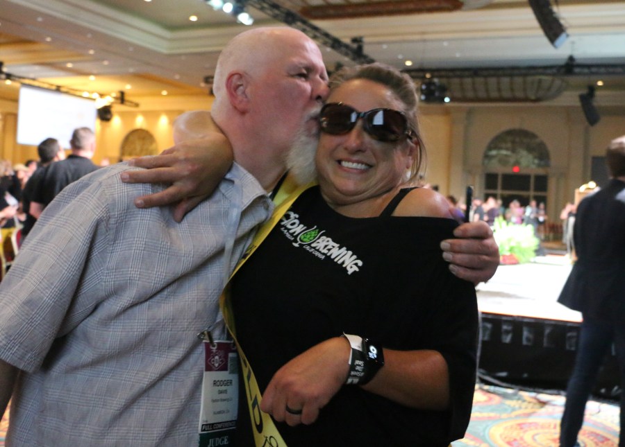 Faction Brewing's Rodger gives Claudia a kiss after leaving the stage with their Gold