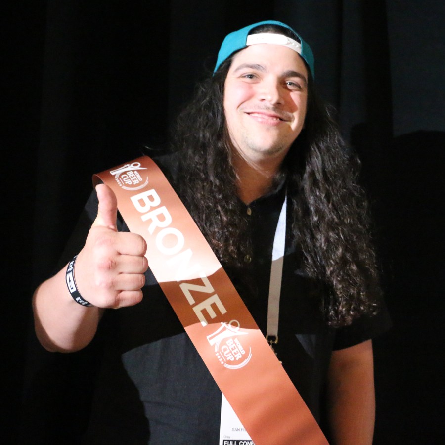 Nick Mamere from SF's Bartlett Hall brewery gives a thumbs up in his winners sash after he wins a Bronze.