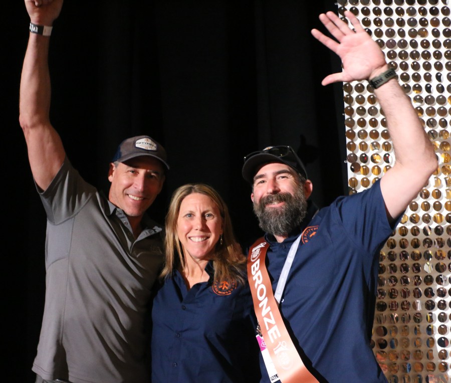 FiftyFifty founders Andy and Alicia Barr and General Manager Jon Mann waving after winning a Bronze