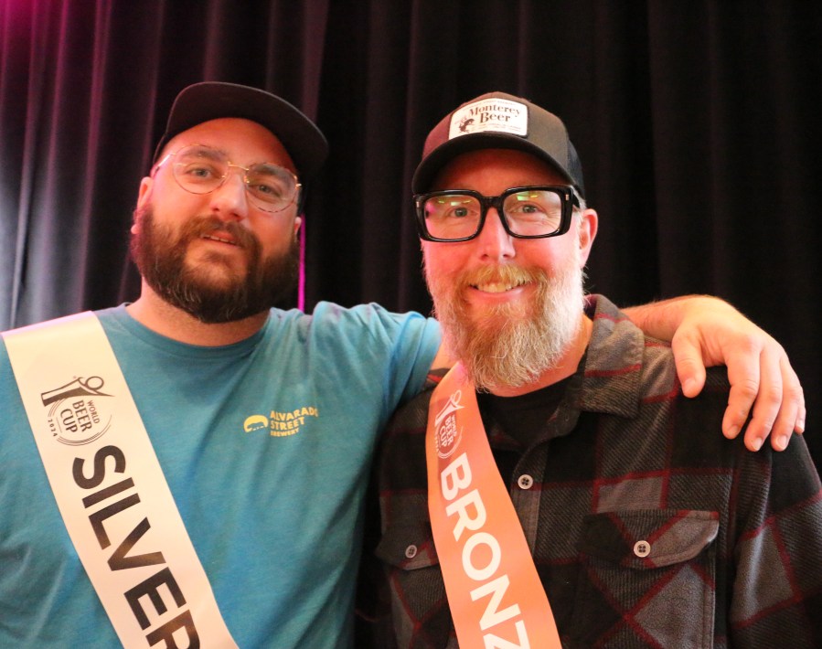 Two members of the Alvarado Street Brewing team stand in the spotlight after their first two awards at the World Beer Cup awards
