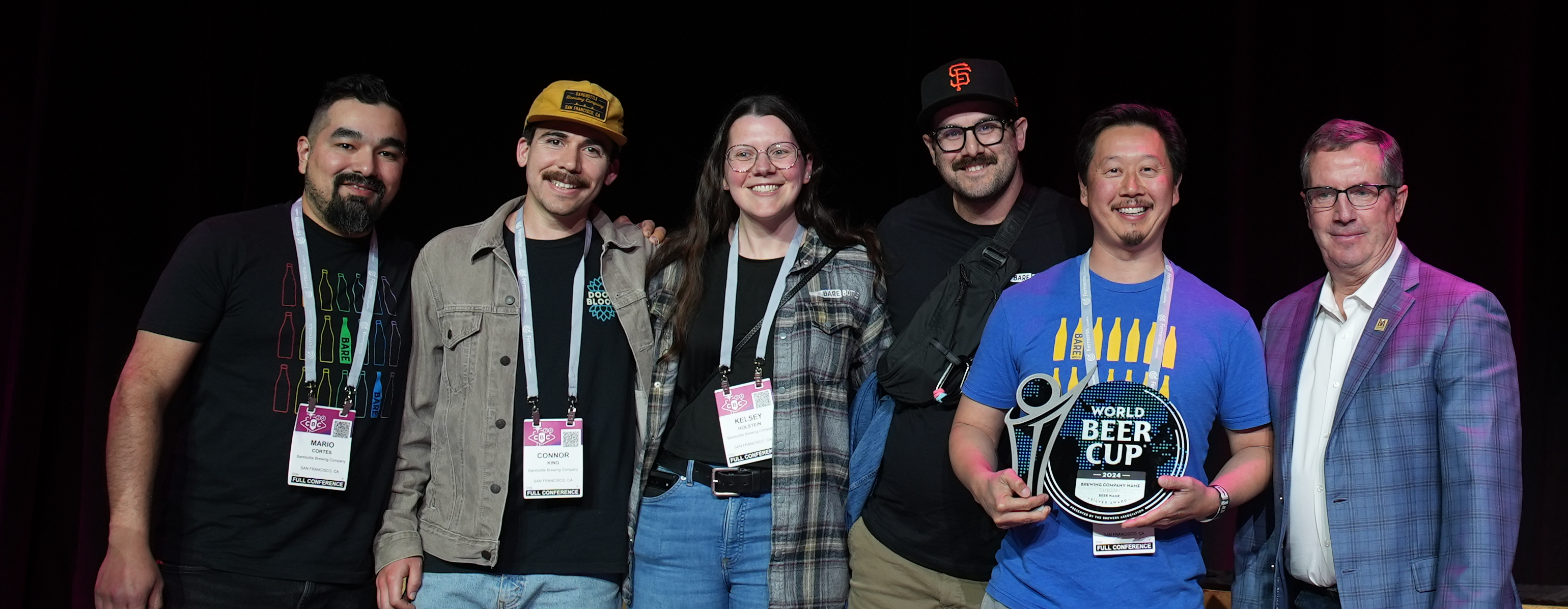 Receiving their Silver on the World Beer Cup stage, five BareBottle Brewing team members can't stop grinning