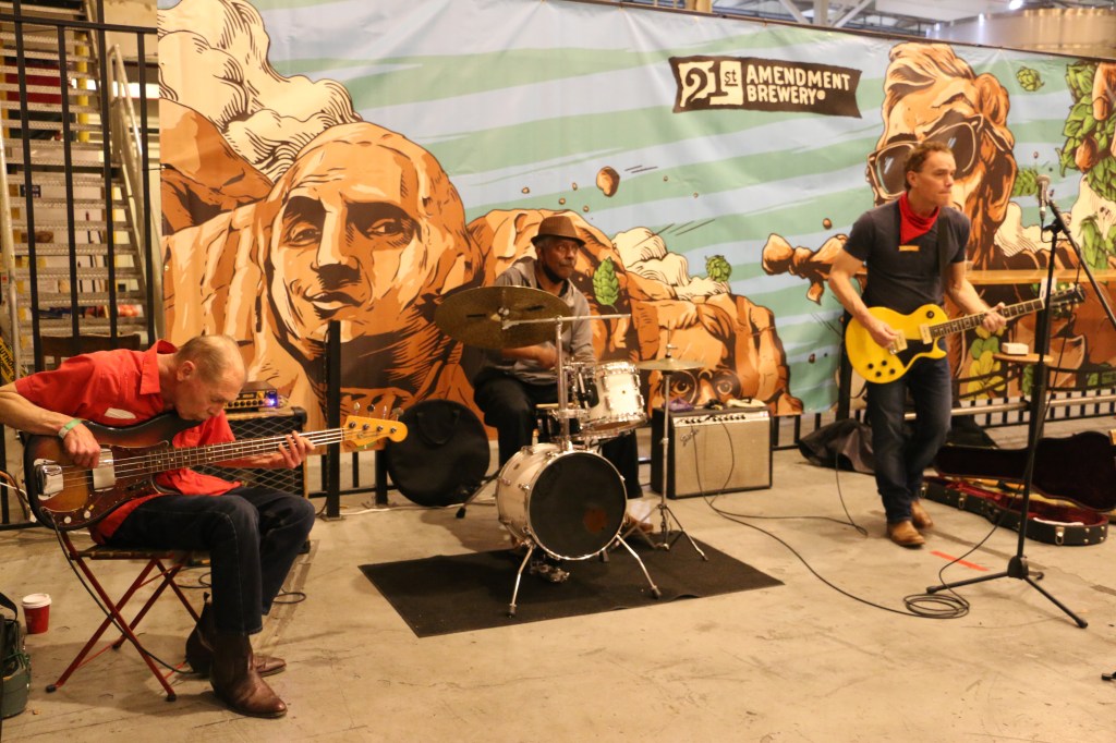 Band plays in from of a 21st Amendment banner with a drawing of Mount Rushmore
